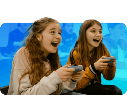 Try Before You Buy - Classwise 20: Two girls excitedly gaming in a classroom setting with a vibrant background.